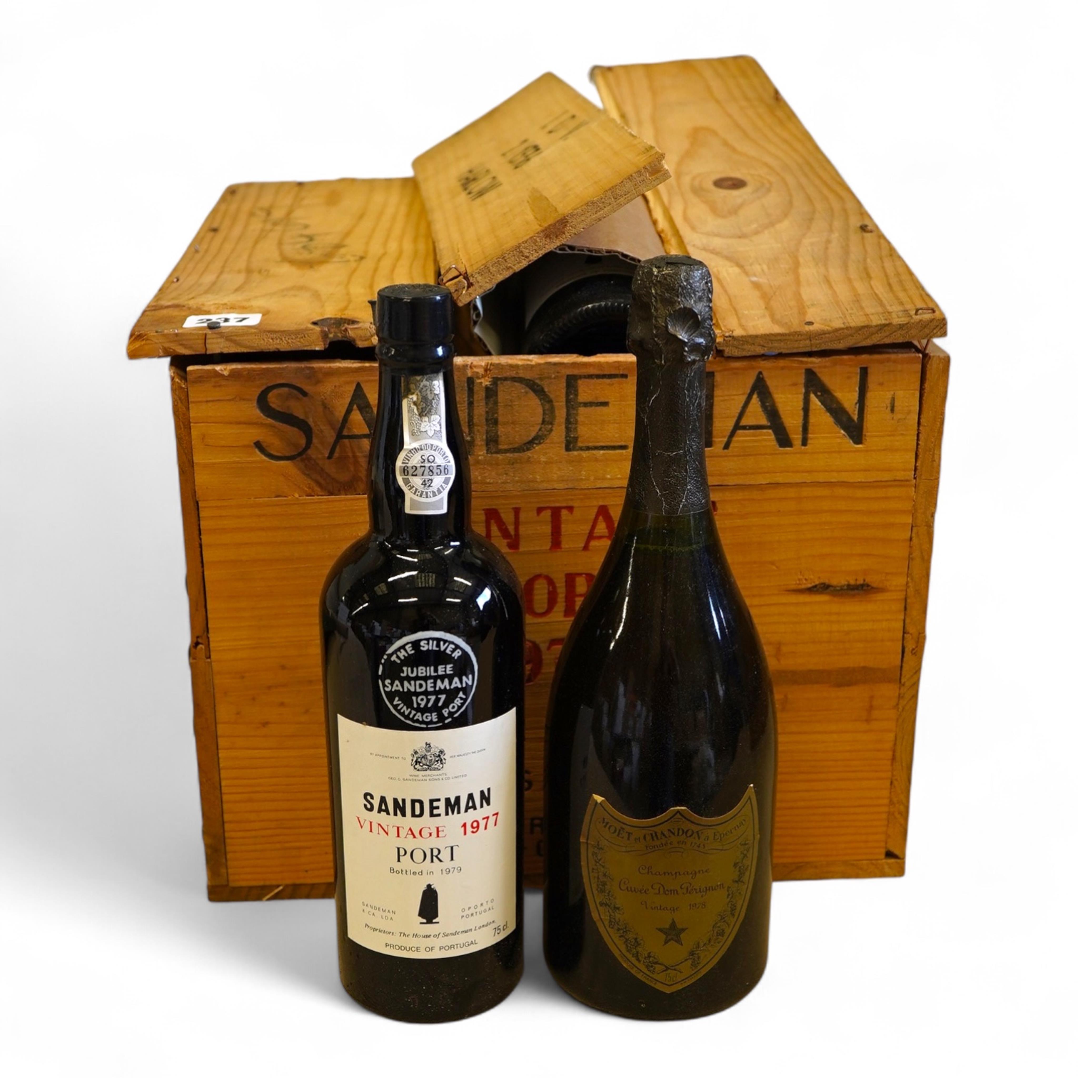 Twelve bottles of 1977 Sandeman vintage port (O.W.C but opened), and a cased bottle of 1978 Dom Perignon champagne
